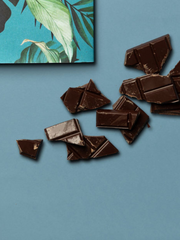 Pedaços do chocolate 70% sobre o fundo azul. 